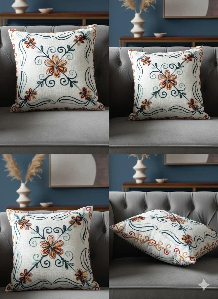 Floral embroidered throw pillow with swirls on gray sofa, home decor accent