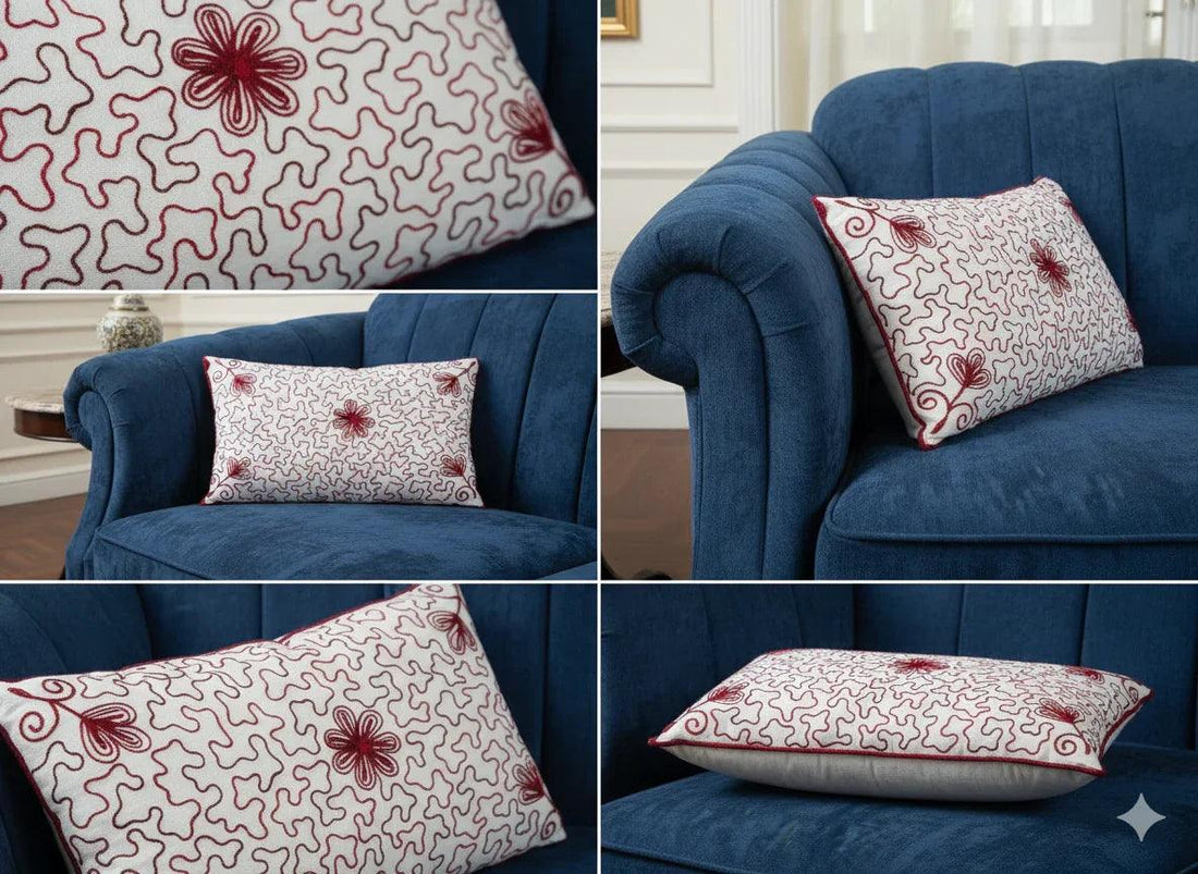 Blue velvet sofa with red floral patterned throw pillow in elegant living room